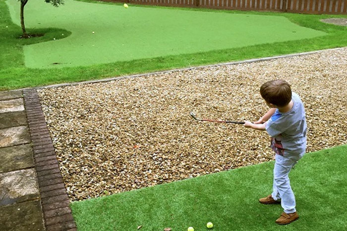 Little Kid Playing Golf in Backyard (photo)
